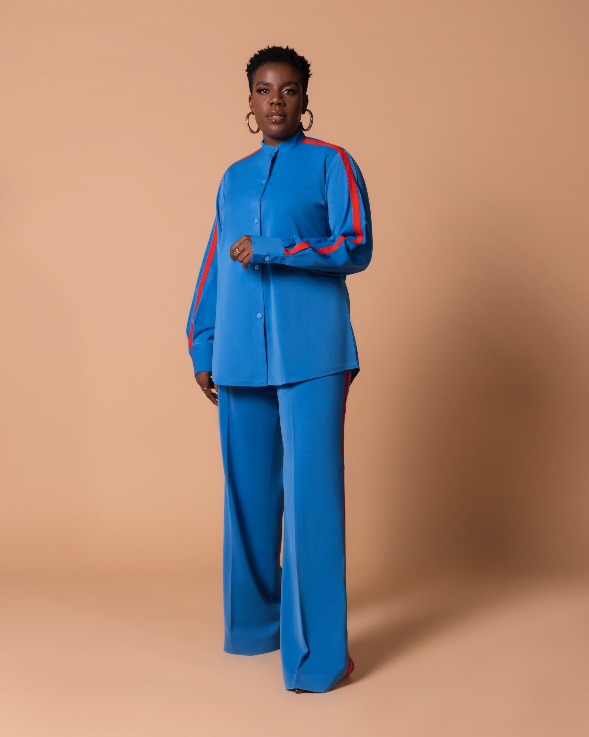 Model wearing Maison Set (Azure) with bishop collar button shirt featuring contrast sleeve stripe and matching high-waist straight-leg pants with double side stripes.