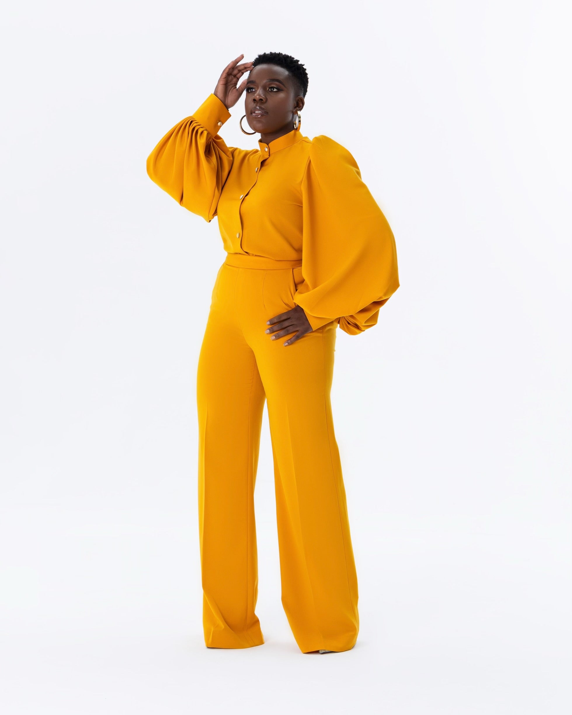 Shabir mustard monotone two-piece set featuring balloon sleeve blouse with bishop collar and gold buttons, styled as a matching set.
