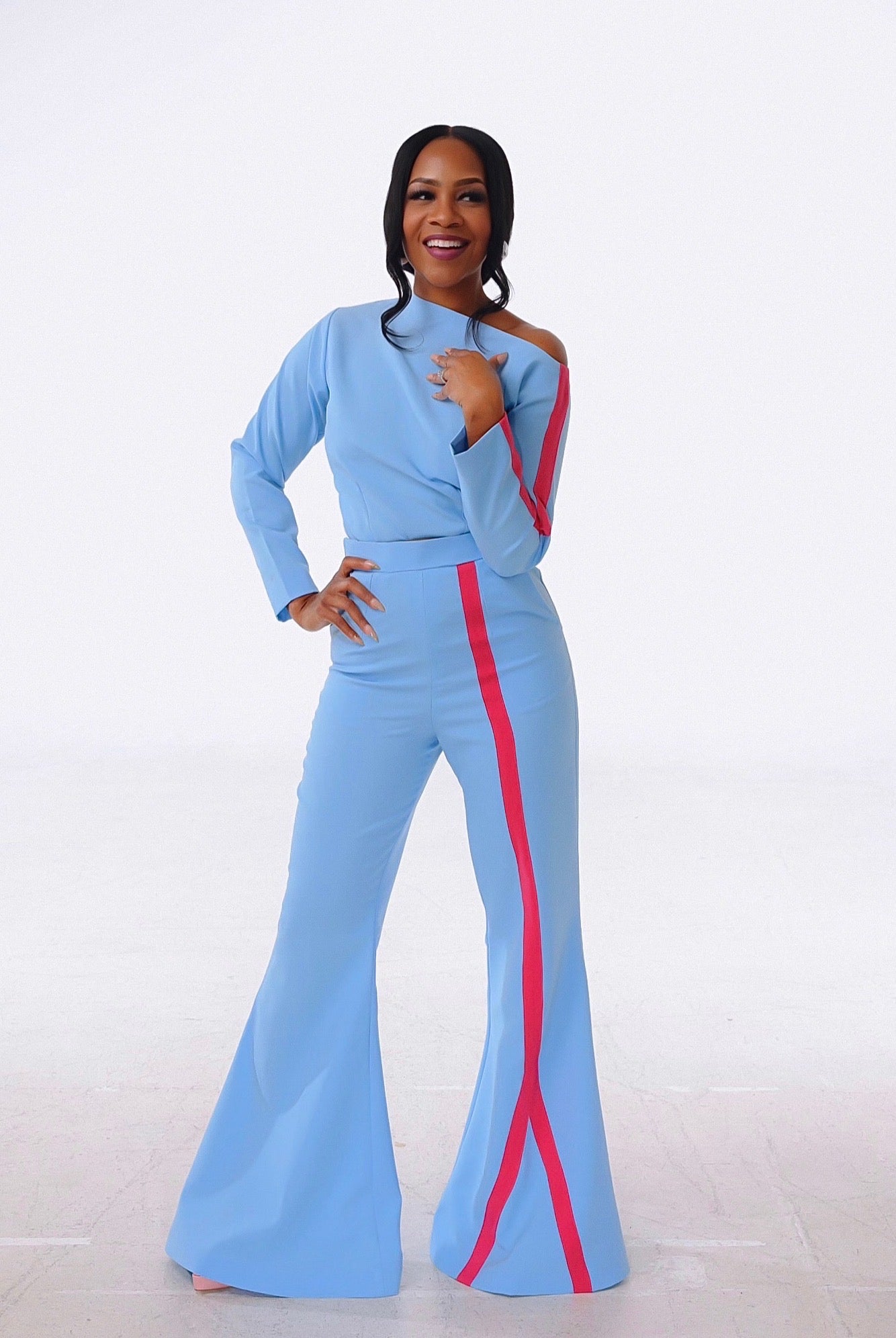 Model is wearing a unique and timeless high-waist pant set with off shoulder for an elegant and flawless look.