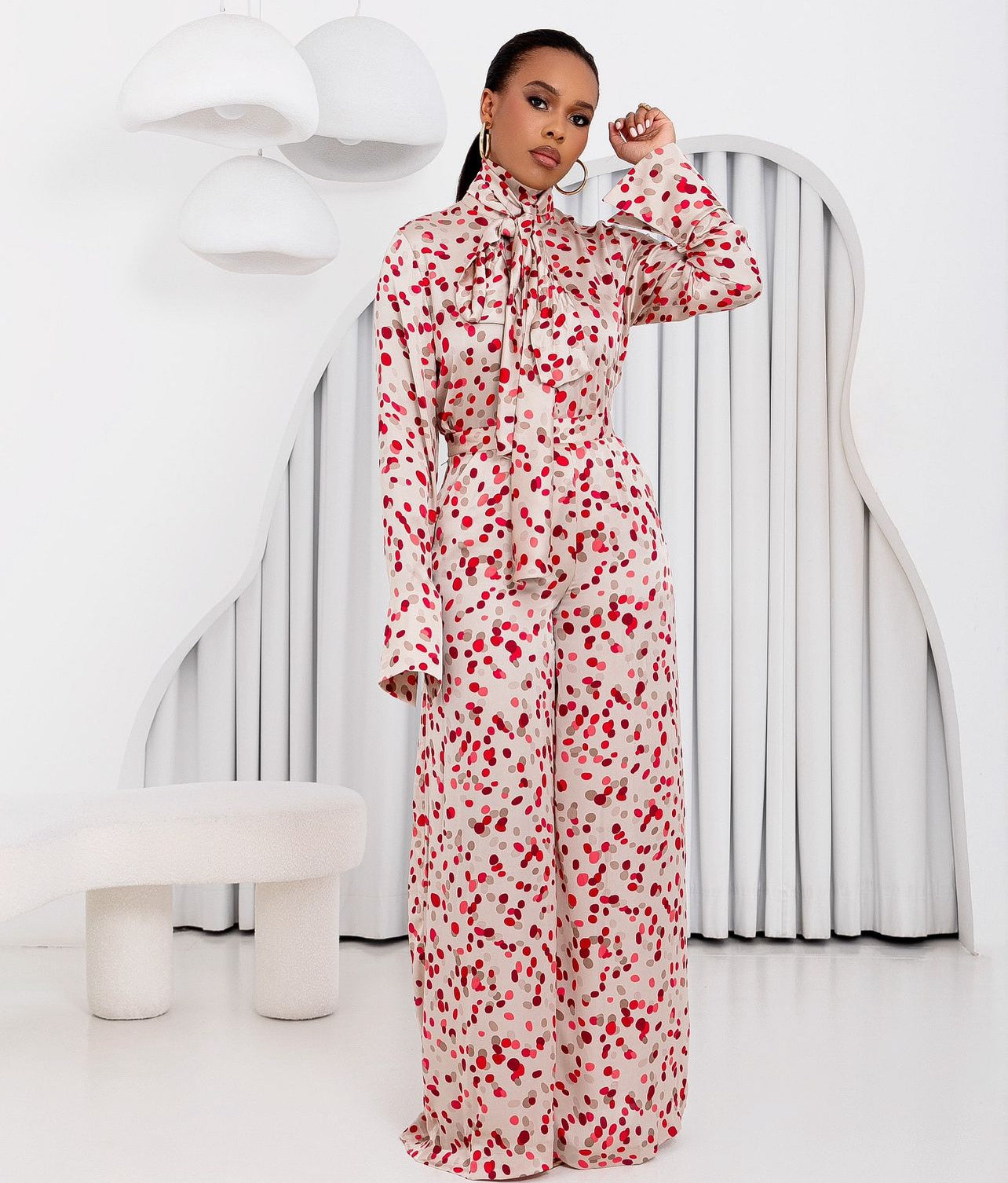 Front view of model wearing Faith Polka Dot Set—high-neck scarf tie top and wide-leg palazzo pants in red polka dot silk print.