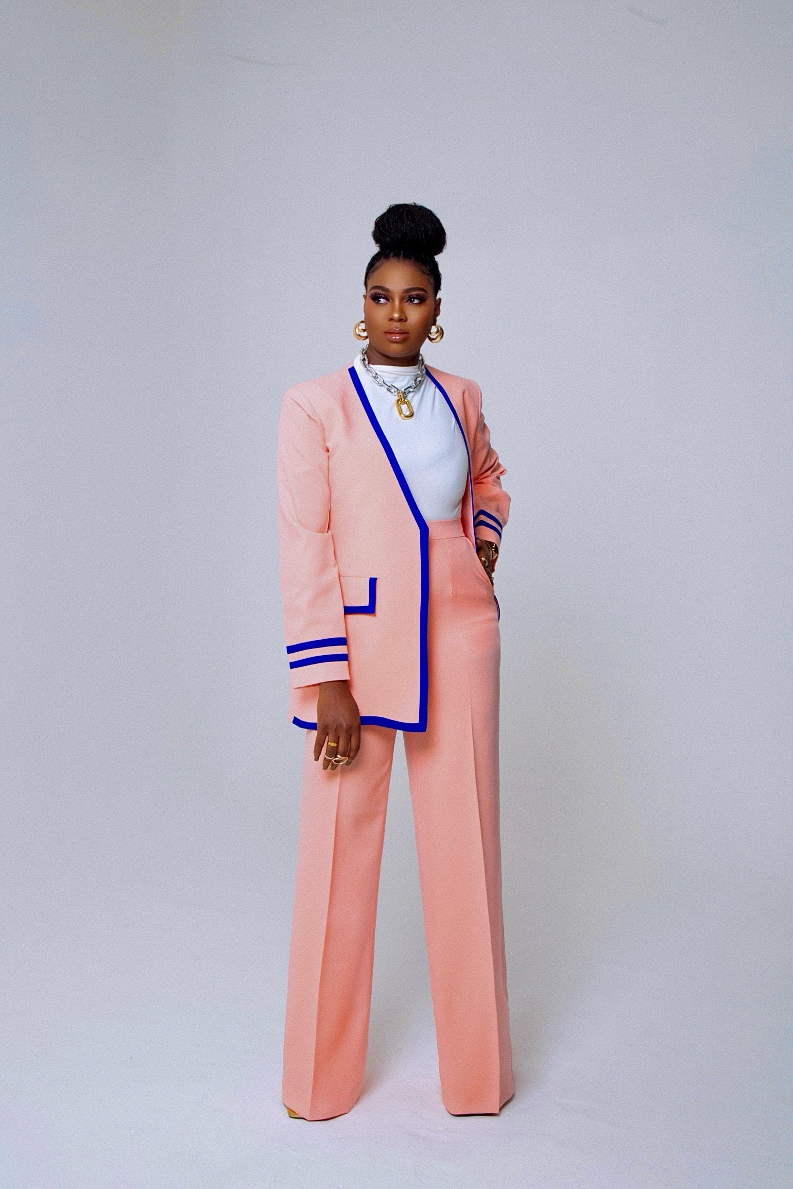 Model wearing Olarsgrace Ase Suit Set in peach and blue – longline blazer and tailored pants for bold women