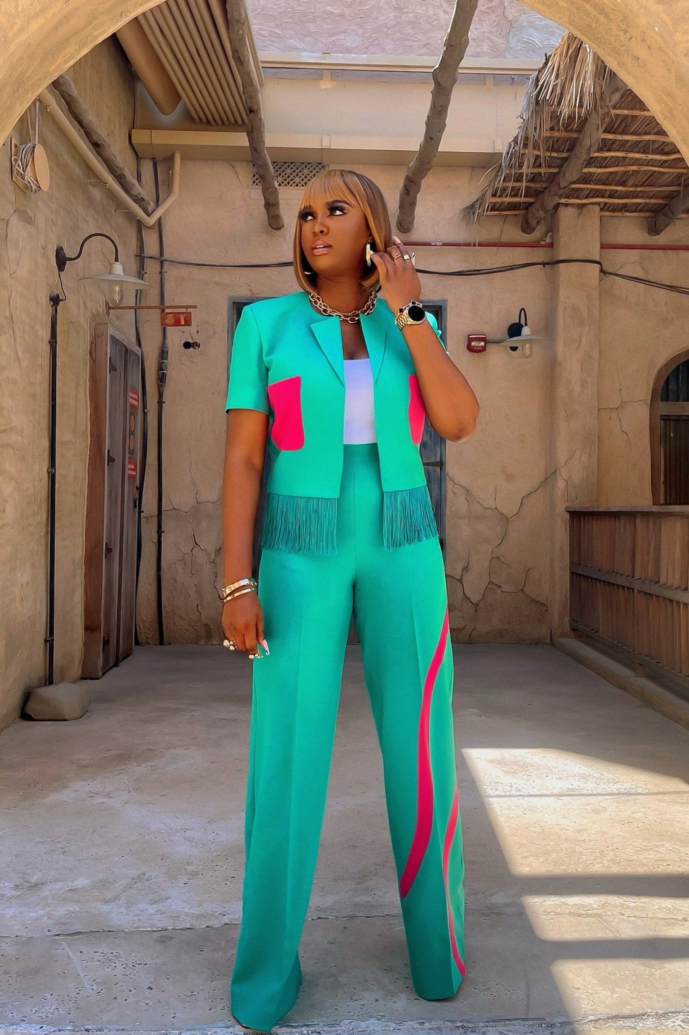 Model wearing the Olarsgrace Fejiro Blazer in teal green with pink accents and fringe detailing