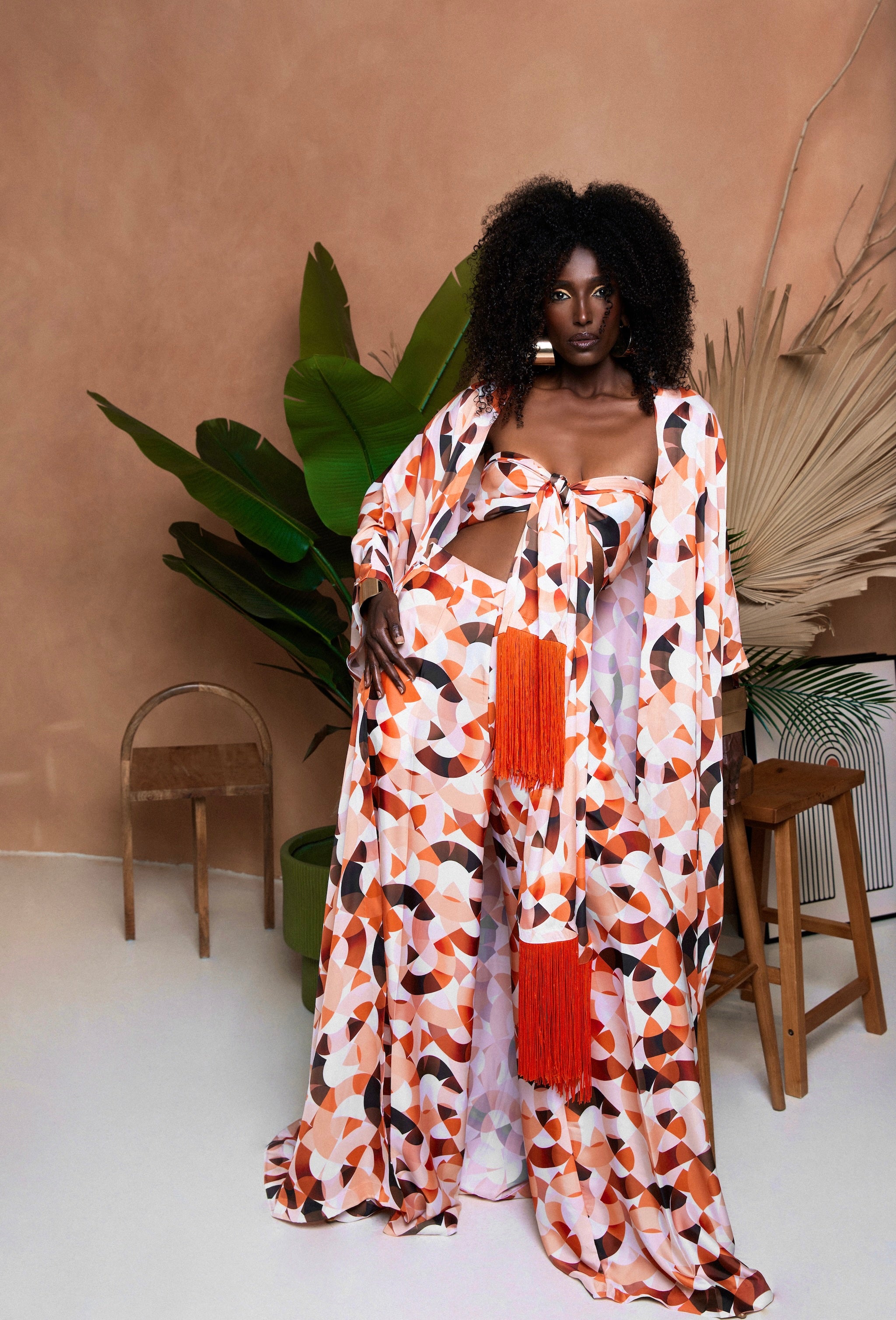 Sprout resort wear three-piece set in multicolor print, featuring long kimono, wide-leg palazzo trousers, and fringe scarf top.