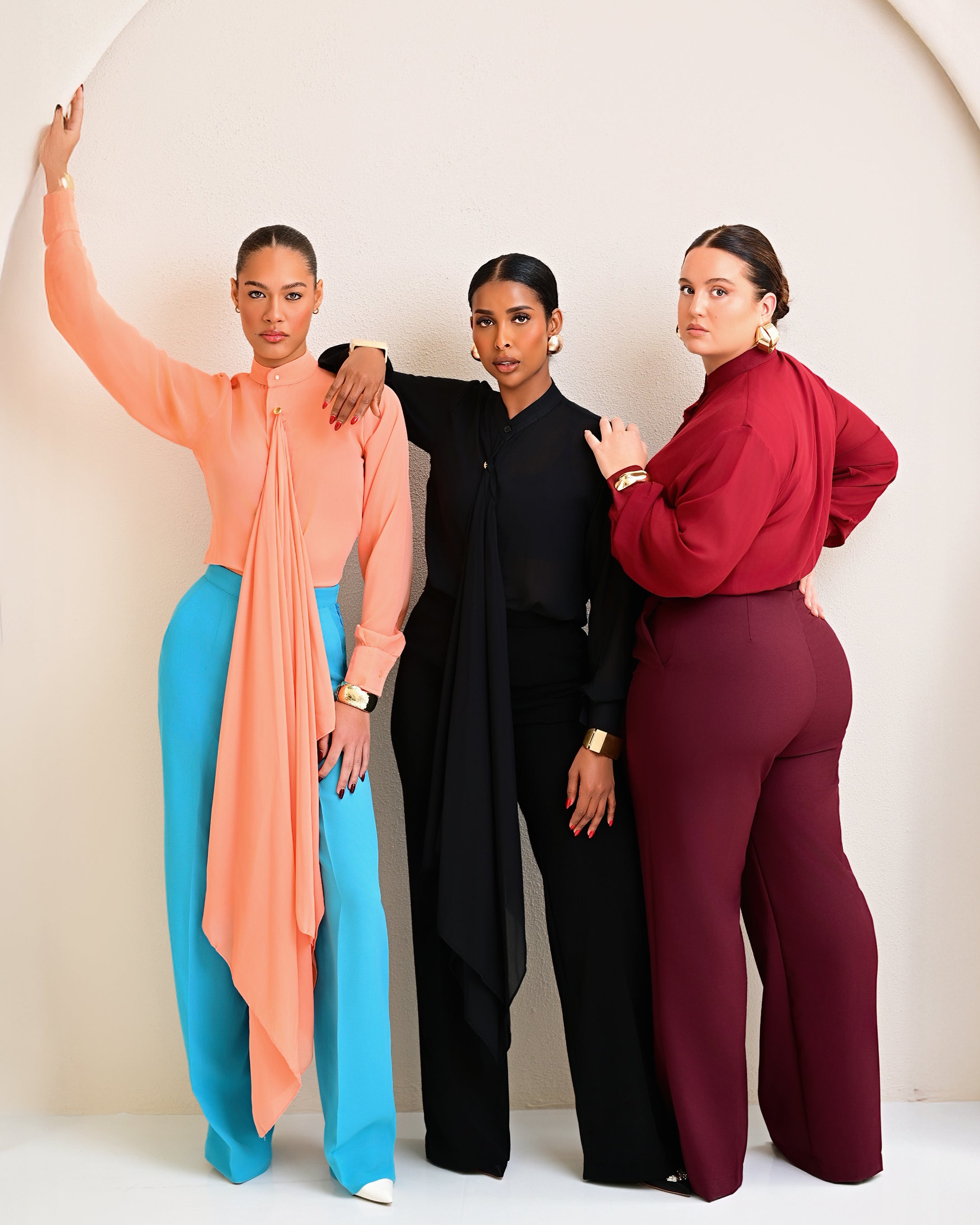 Model is wearing Tabitha Set in Black colour with bishop collar neck blouse with neck-down flair detail, hidden button placket and matching high-waist straight-leg pants with pockets.