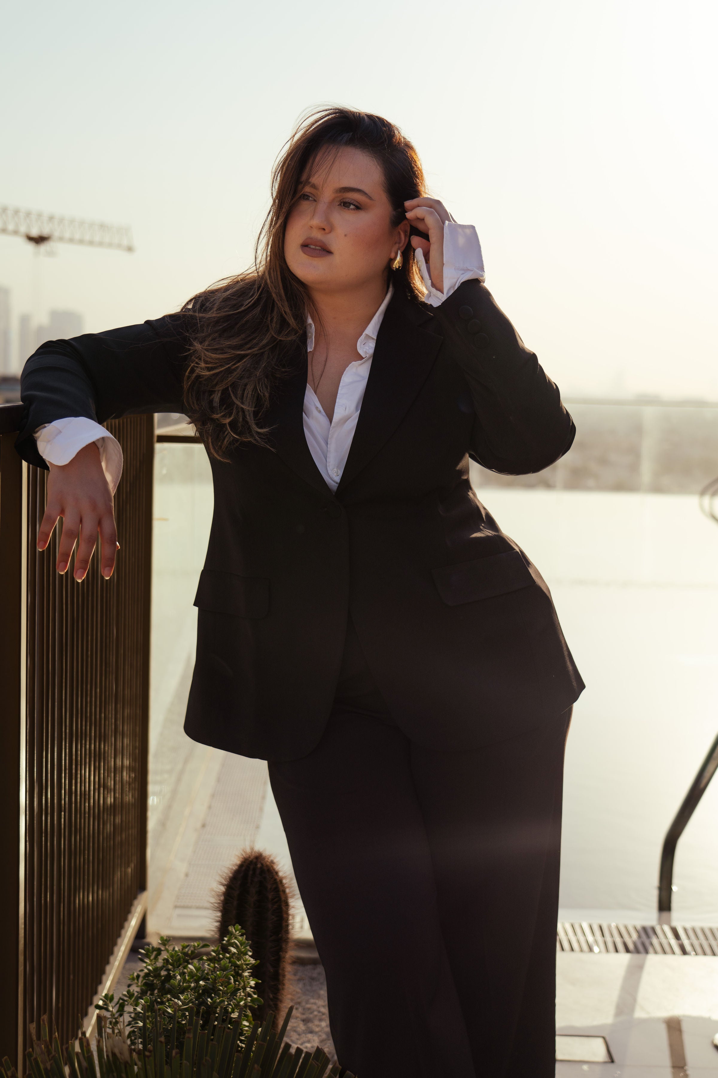 Toby black suit with structured single-button blazer and tailored trousers, styled with white shirt and heels for a modern power look.