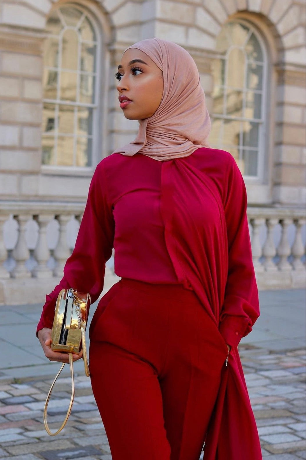 Model in the Wine Tabitha set styled with chiffon blouse and high-waist straight-leg pants for an elegant occasion-ready look.