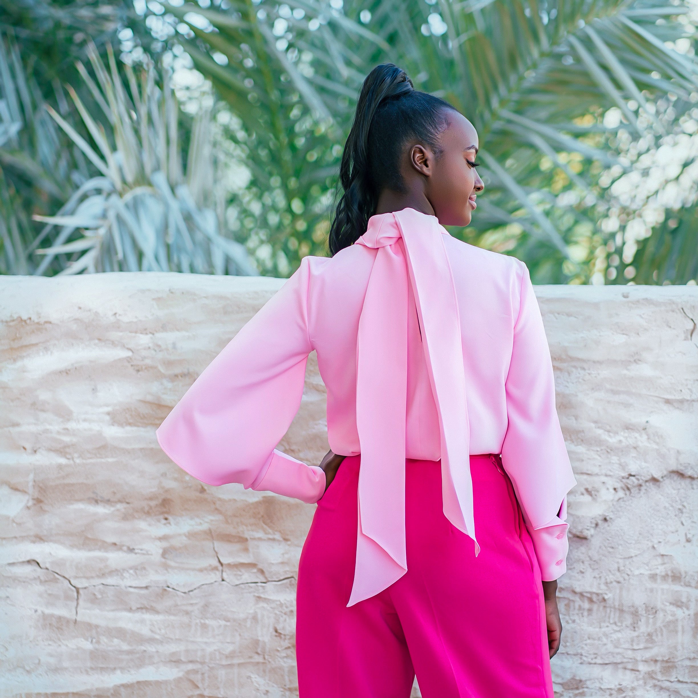 Back detail of the elegant Olarsgrace Najma Set showing adjustable neck ties paired with fuchsia high-waist straight-leg trousers