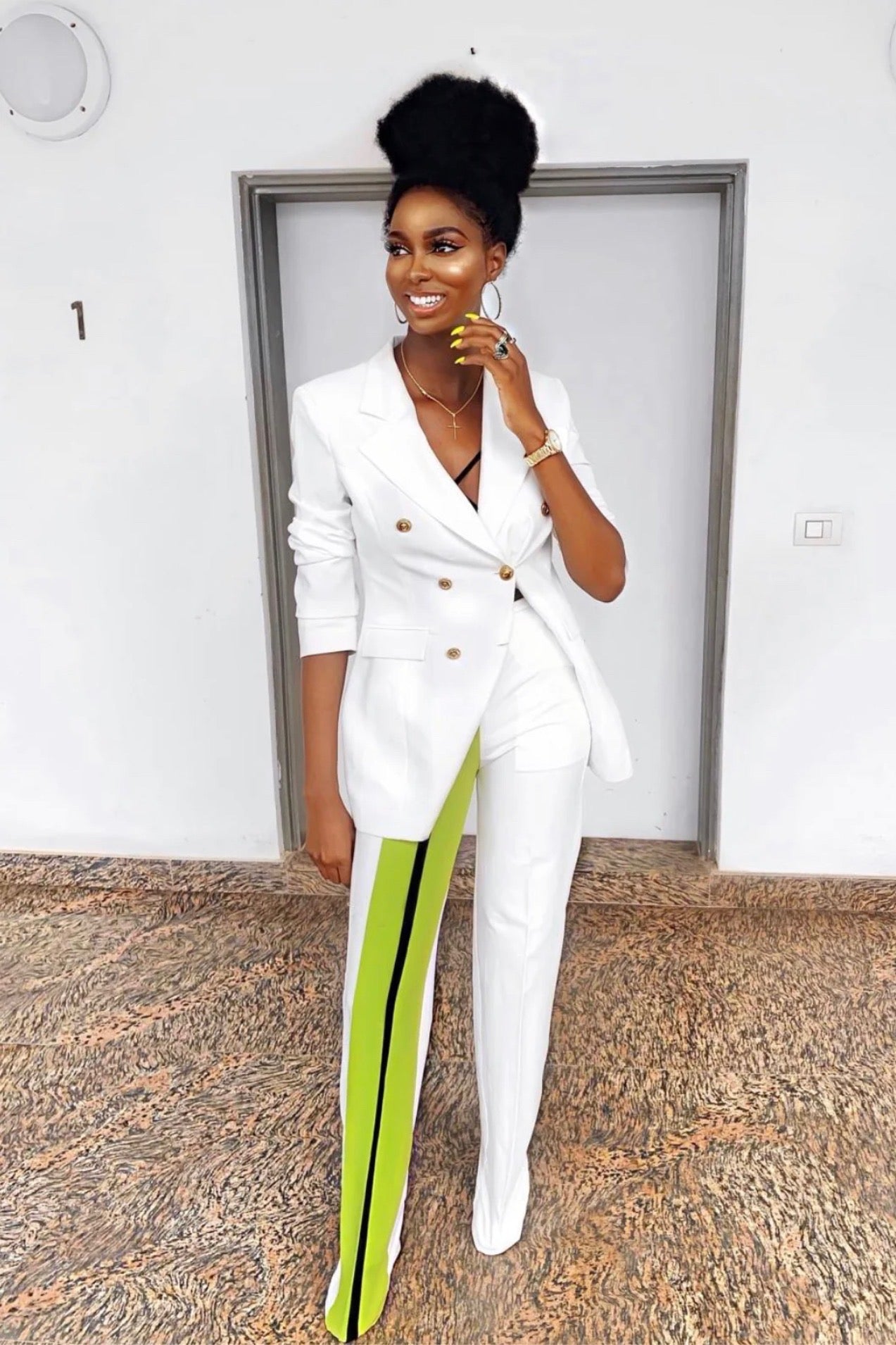 Model wearing a Pop Suit Set, featuring a white blazer and high-waist straight pants with a neon-striped detail 