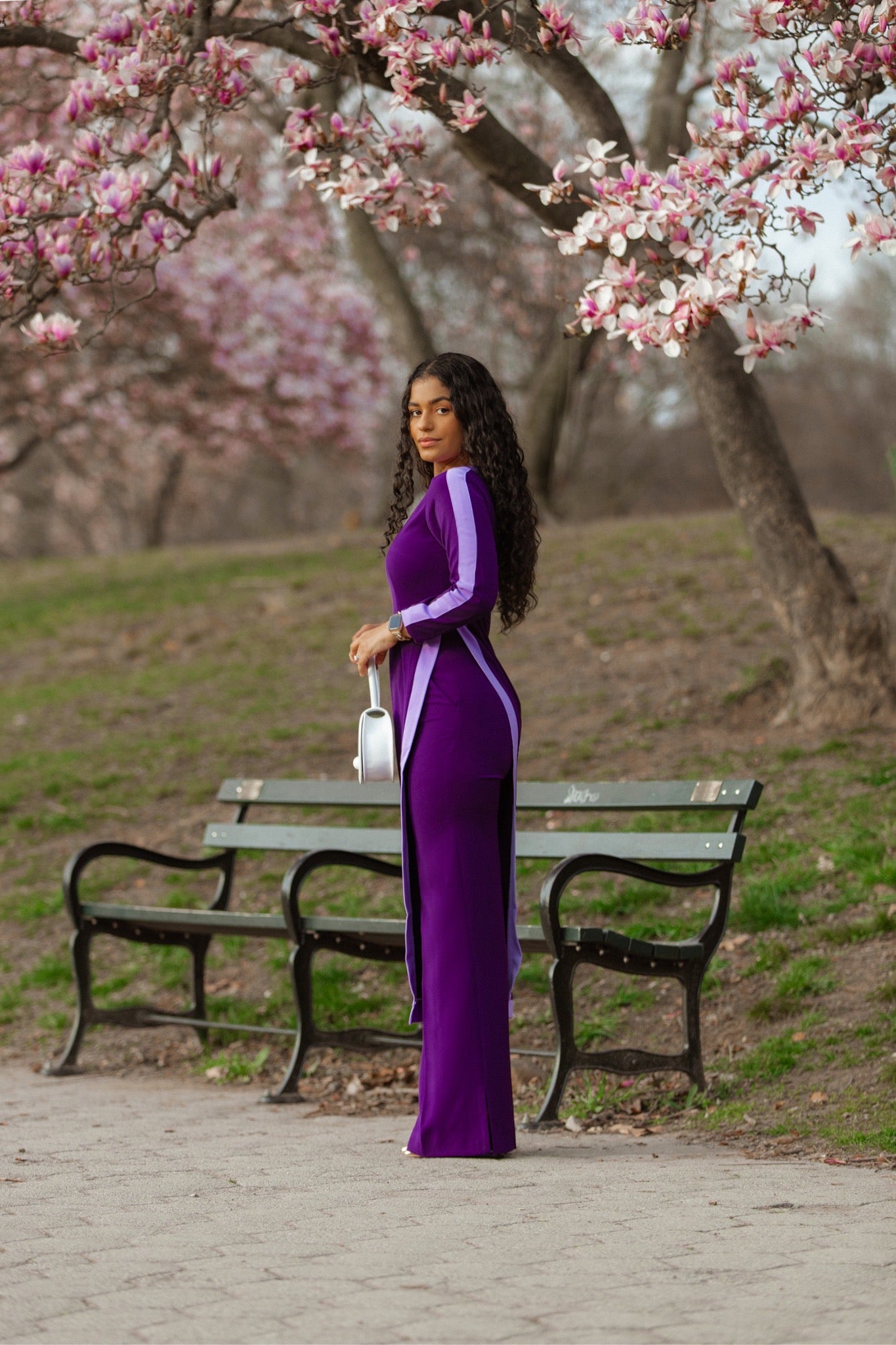Side view of an elegant purple tunic co-ord with lilac stripe trim—longline top layered over high-waist straight-leg pants.