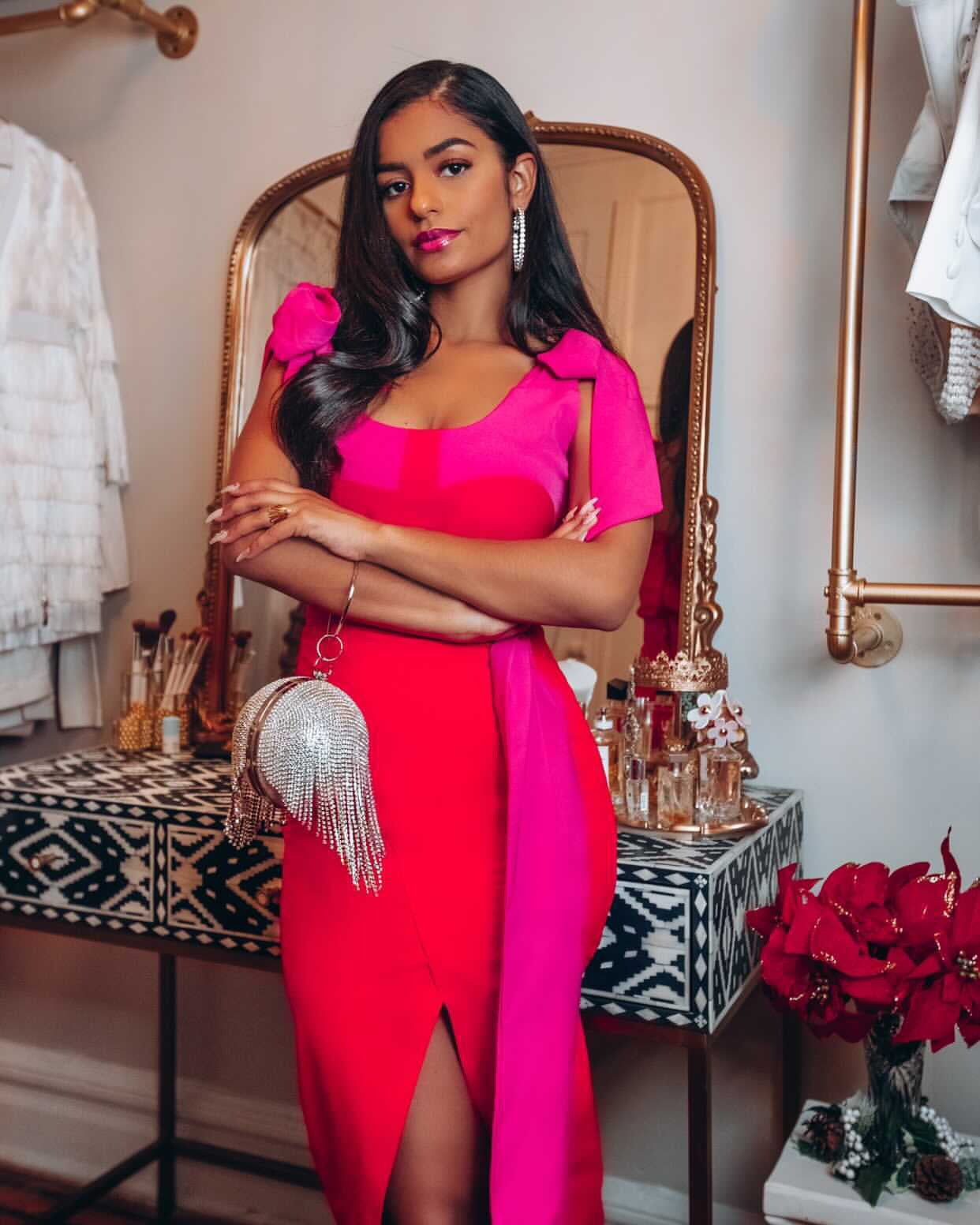 Model wearing Latifa luxury red and pink colour block set by olarsgrace. It features a tie-shoulder crop top and high-waist red midi skirt featuring pink waistband, side belt detail and front slit.