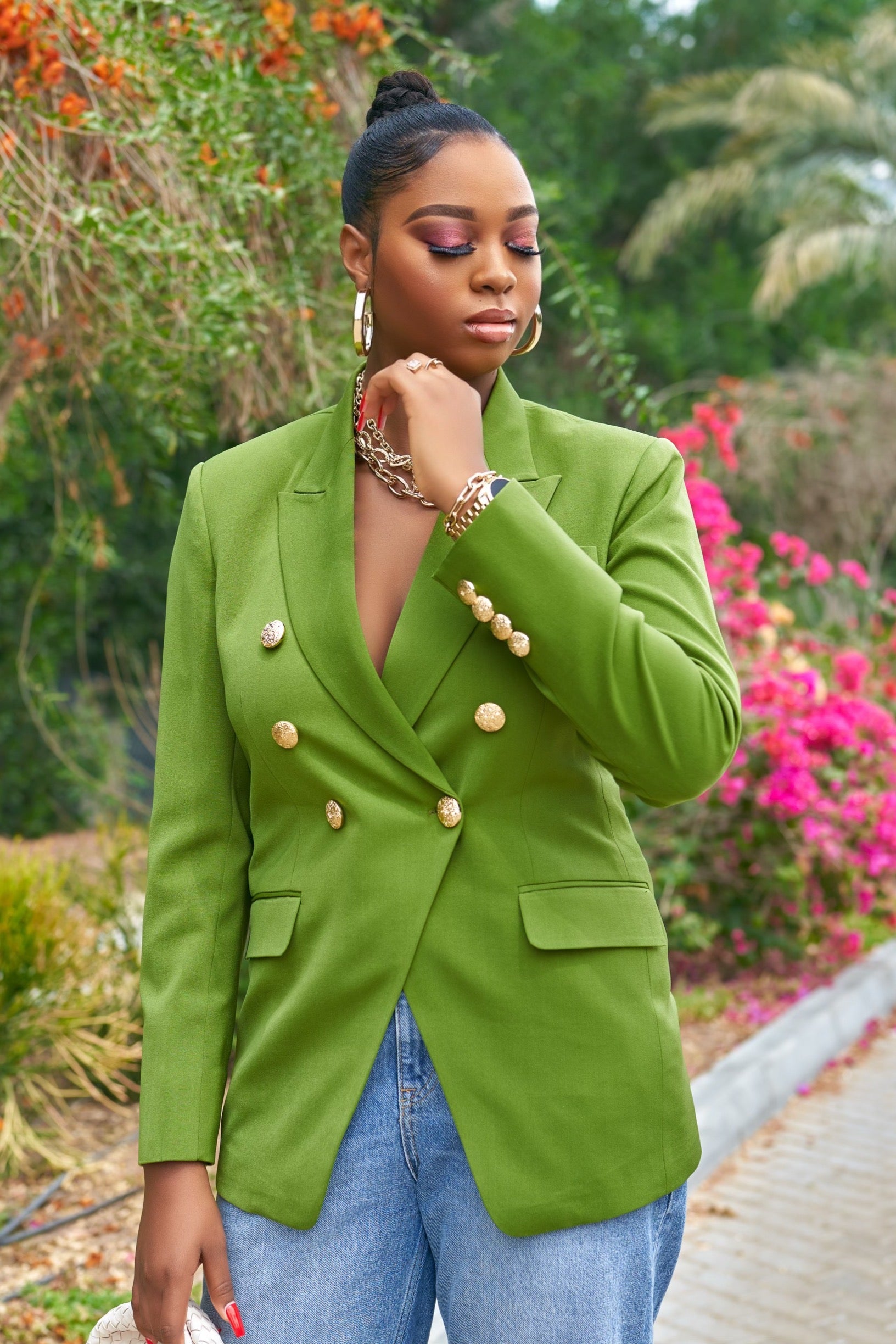 Neil Olive Green blazer with gold-tone buttons, worn with high heels and distressed jeans outdoors
